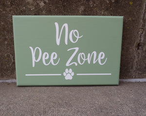 No Pee Zone sign in light green with white letters 