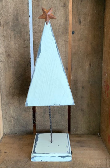 Christmas tree with rusty star in distressed cottage style for home decorations. 