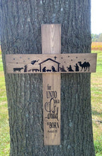 Load image into Gallery viewer, This Christmas Cross with Nativity offers a meaningful touch to your holiday decor. Handcrafted from wood and stained brown, this wall hanging features a black silhouette of a classic nativity scene with the phrase “For unto us a child is born”. Hang it in any interior room, or on a sheltered porch for an extra special accent piece.