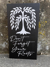 Load image into Gallery viewer, The Don&#39;t Forget Your Roots Sign is a beautifully crafted wall hanging made from natural wood, accented with a sleek black finish. Remind yourself to stay grounded with this stylish and meaningful addition to your home decor. 