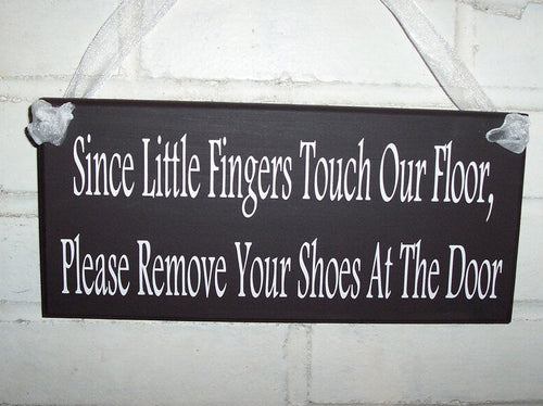 Decorative door sign for families with small children.  Kind way to ask others to remove their shoes at the door. 
