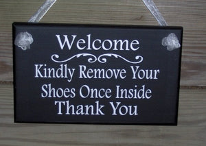 Kindly welcome guests with this elegant front door sign.  The sign also requests that your guests remove their shoes once inside.  