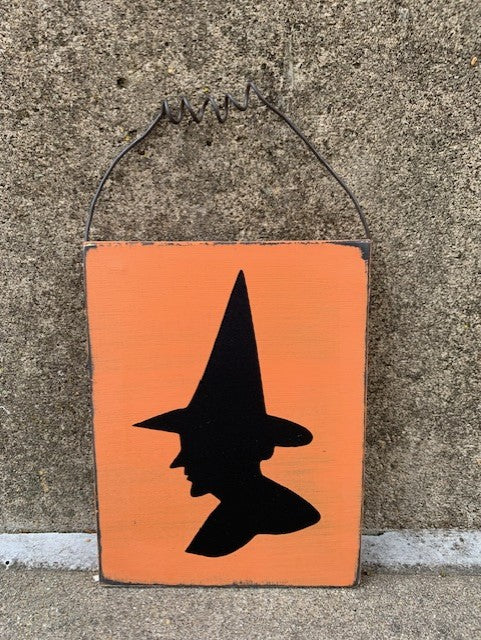 Fall Halloween decorations for the home.  Handcrafted in a rustic farmhouse style in black and orange with a witch head silhouette. 