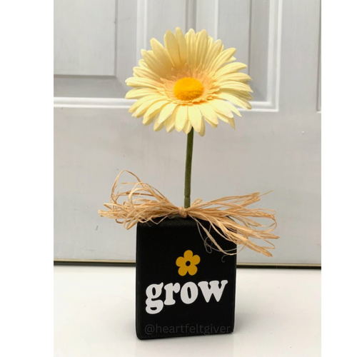 grow wood block sign with faux flower in black and yellow signage
